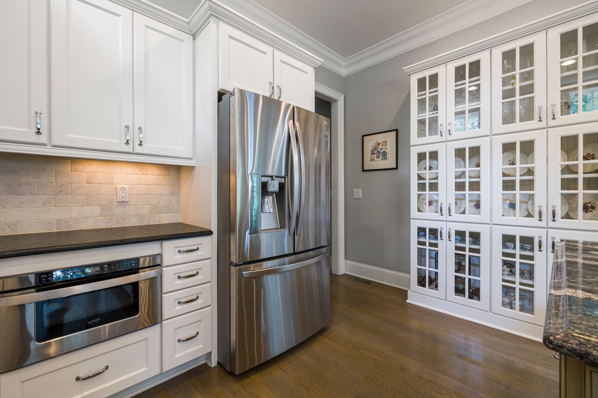 A contemporary kitchen with a full run of fitted appliances